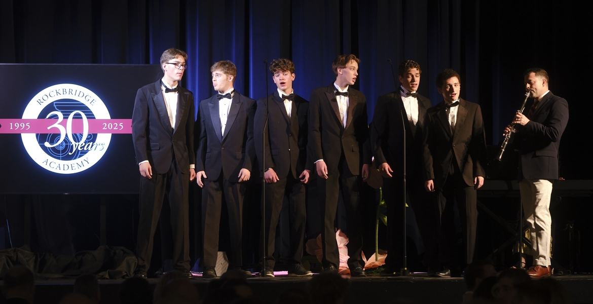 Rockbridge Academy students sing with a clarinet accompanist during the 30th Anniversary Celebration